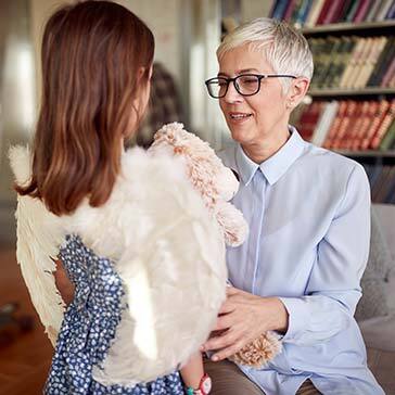 Grandma enjoys spending time with her granddaughter in a relaxed atmosphere at home. Family, leisure, together