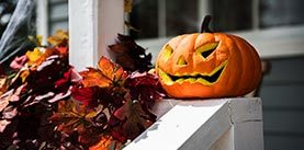 Halloween pumpkins and decorations outside a house